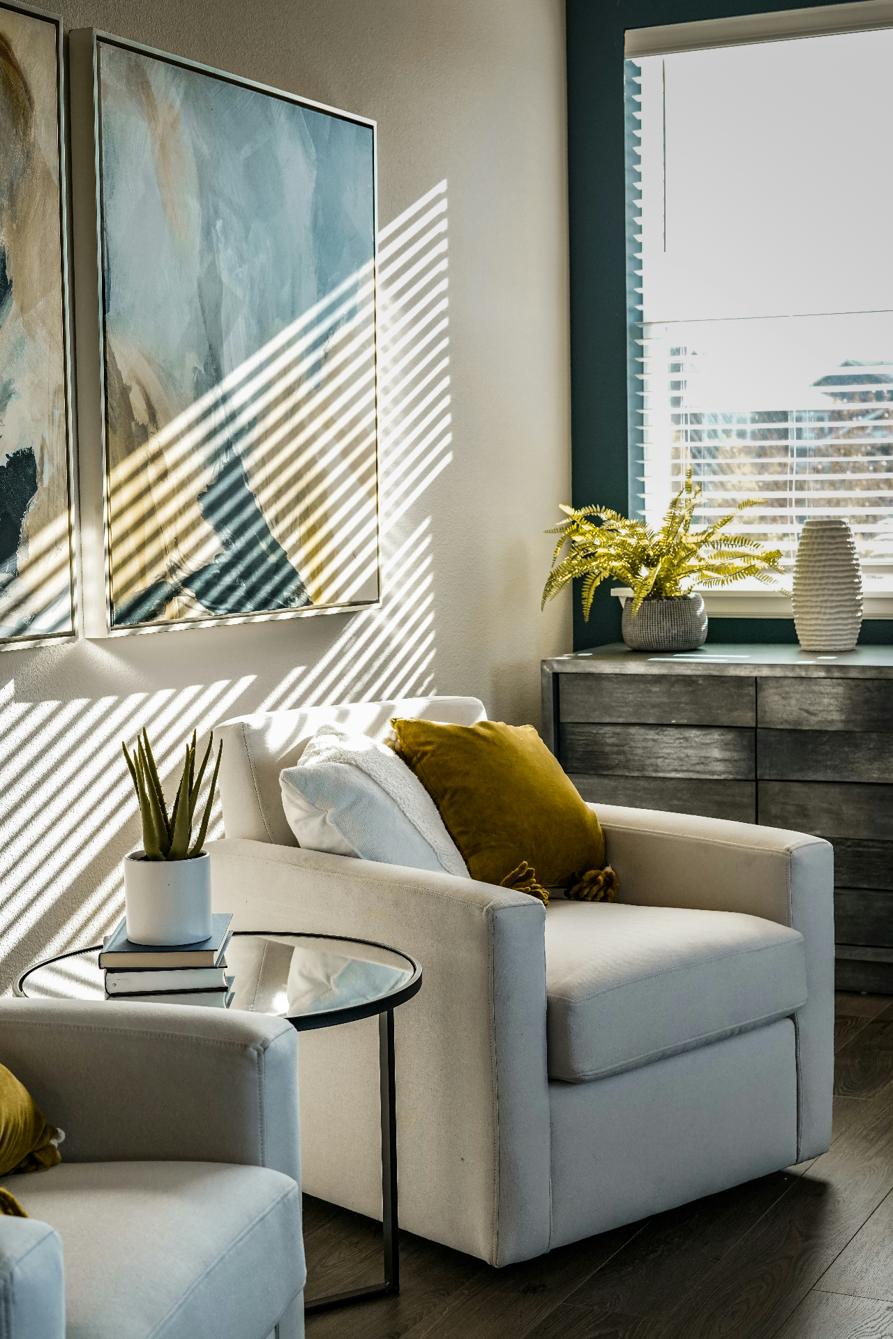 A calm woman reading on a linen sofa in a sunlit living room